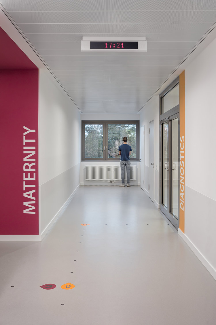 Routing systems on the floor in hospital helps wayfinding, created with nora floor coverings.